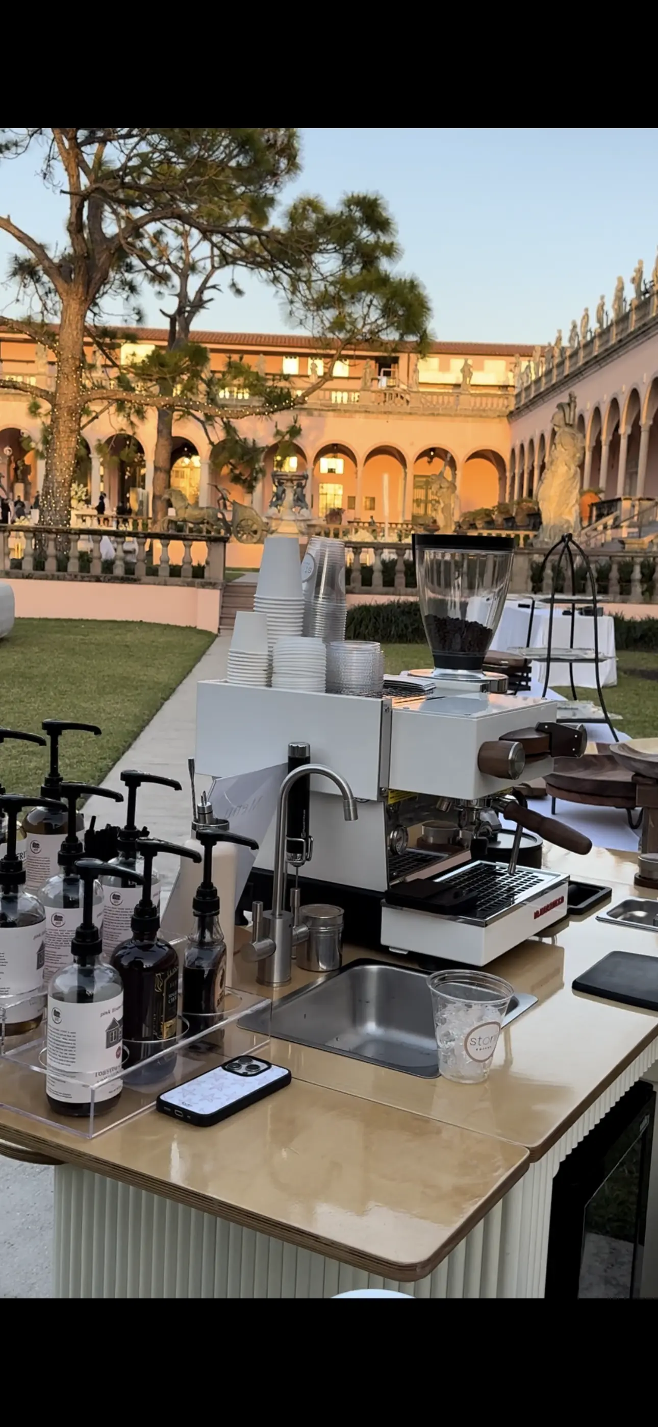 Espresso bar set up in a museum courtyard at golden hour