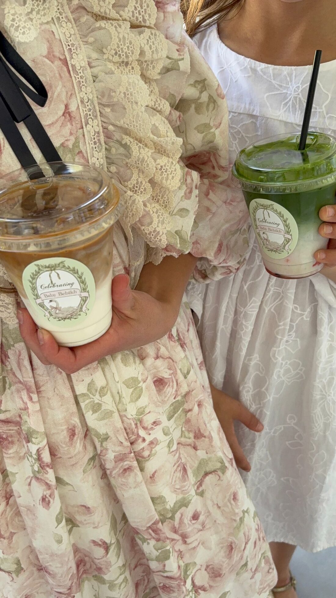 Guests holding custom-labeled iced latte and matcha drinks
